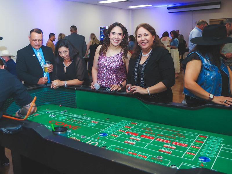SWTJC Staff Delia Ledesma and Areli Fisher pose for a photo while playing casino games.